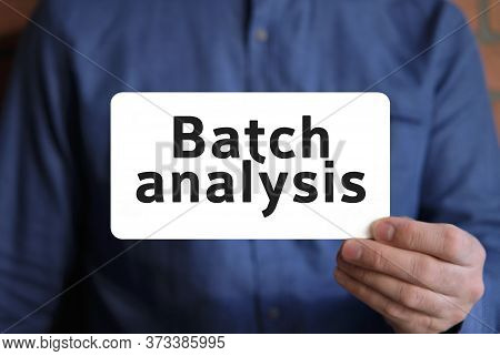 Batch Analysis Text On A White Sign In The Hand Of A Man In A Blue Shirt
