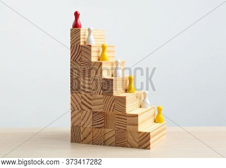 Red Piece Overtopping Other Ones On Wooden Stairs. Career Promotion Concept