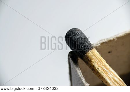 Isolated Match Stick Kept Over The Edge Of A Matchbox In A White Background. Space For Text In Left