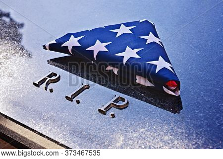 Folded Into Triangle American Flag On Memorial Marble Tomb With R.i.p. Text. Flag Folding Ceremony I