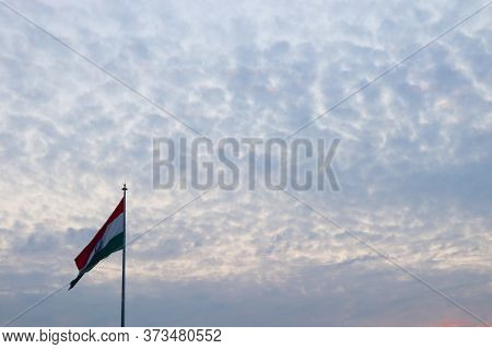India Flag With Coludy Sky In The Background