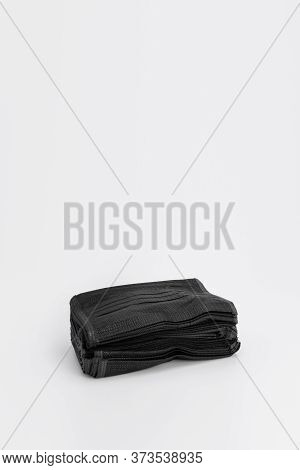 Isolated New Hygienic Mask Black Colour On The White Background In Studio Light.