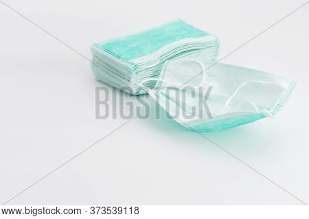 Isolated New Green Hygienic Mask On The White Background In Studio Light.