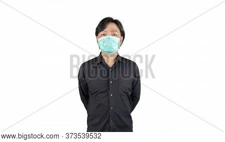 Asian Middle Man In A Black Shirt, Wears A Green Hygienic Mask, And Crosses His Arm Backside, Stands
