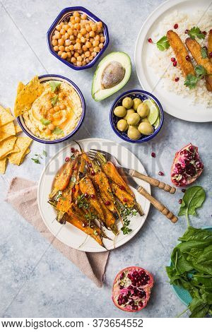 Variety Of Healthy Snacks, Gourmet Dips And Nuts. Hummus,  Roasted Carrots, Rice With Tempeh In Cera