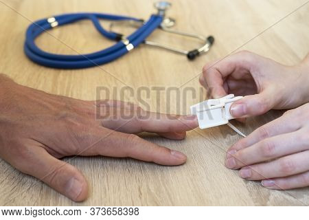 Doctor Putting A Plater Band-aid On Patient Finger Close-up, Hands Only
