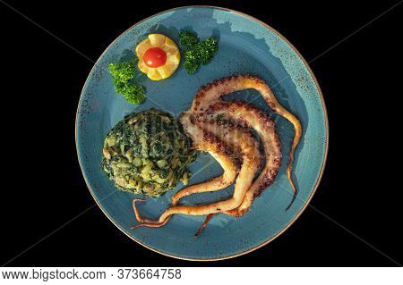 Balkan Cuisine. Dish With Grilled Octopus With Chard Leaves ( Blitva ) And Potatoes, Isolated On Bla
