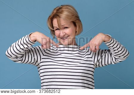 Happy Mature Woman Pointing Fingers At Herself. Select Me Please Concept.