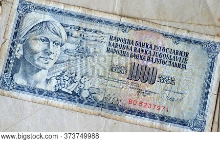 Obverse Of 1000 Dinar Paper Bill Issued By Yugoslavia That Shows Portrait Of Woman And Agriculture