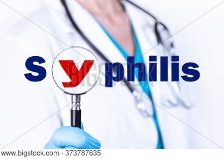 Syphilis Text Is Written On The Background Of A Doctor Holding A Magnifying Glass. Medical Concept.