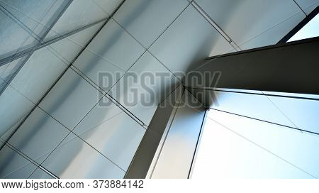 Combination Of Metal And Glass Wall Material. Steel Facade On Columns. Abstract Modern Architecture.
