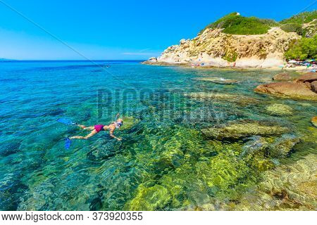 Female Bikini Snorkeling In Cotoncello Beach Near Popular Sant Andrea Beach In Elba Island. Snorkele