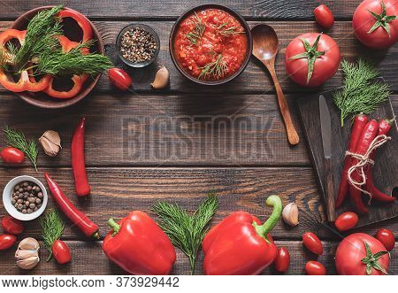 Balkan Sauce Ajvar And Ingredients For Its Preparation On A Wooden Table With A Copy Space. Serbian 