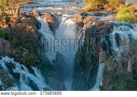 Part Of The Epupa Waterfalls In The Kunene River At Sunset. Baobab Trees Are Visible