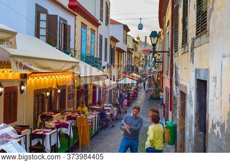 Funchal, Maderia Isalnd, Portugal - Feb 04, 2020: People At Restaurants Street. Madeira Island - Fam
