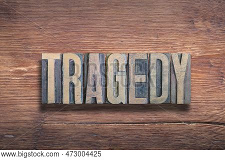 Tragedy Word Combined On Vintage Varnished Wooden Surface