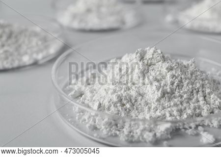 Petri Dishes With Calcium Carbonate Powder On White Table, Closeup