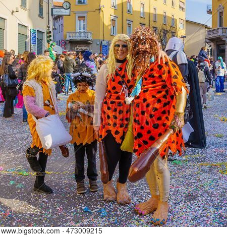 Cantu, Italy - February 25, 2023: Carnival Parade, With Family In Flintstones Costumes, In Cantu, Lo