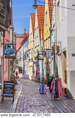 Bremen, Germany - May 18, 2022: Signs And Merchandise On The Cobblestoned Street Of Schnoor In Breme