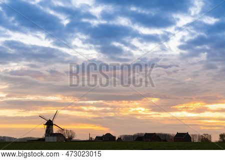 Early In The Morning There Is A Beautiful Windmill Whit The Sun Rising In The Sky