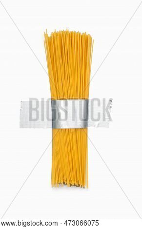 Long Raw Spaghetti Is Taped To A White Wall With Gray Shiny Duct Tape. Raw Spaghetti And Constructio