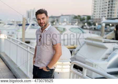 Portrait Of Handsome Male Model Outdoor. Stylish Man Dressed In Polo. Fashion Male Posing On The Str
