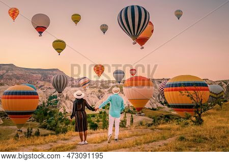 Cappadocia Turkey During Sunrise, Couple Mid Age Men And Woman On Vacation In The Hills Of Goreme Ca