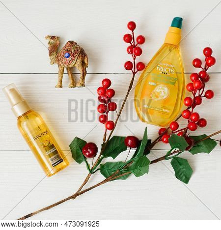 Kiev, Ukraine. March 2023. Garnier Fructis Hair Elixir And Pantene Pro V Hair Oil On A White Wooden 
