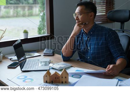 Entrepreneurs, Business Owners, Accountants, Real Estate Agents, A Young Man Using A Calculator To C