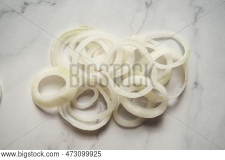 Ring Sliced Onions On White Marble Background. Photo Show How Does Onion Sliced Into Thin And Thick 