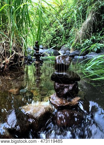 Balanced Zen Rock Stacks In A Creek,view Of A Creek With Stacked Stones On A Rock