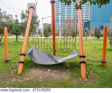 Hammock Of An Unusual Shape. Infrastructure In The Park. Place For Rest. Bench. Modern Park. After T