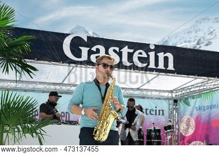Austria, Sportgastein - March 18, 2023: Event Palmen Auf Den Almen, Saxophonist Plays In An Open Are