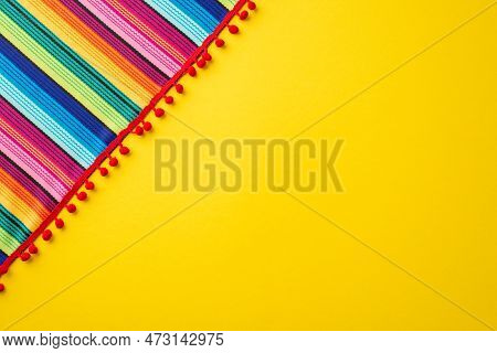 Mexican National Holiday Concept. Top View Photo Of Colorful Striped Serape On Isolated Bright Yello