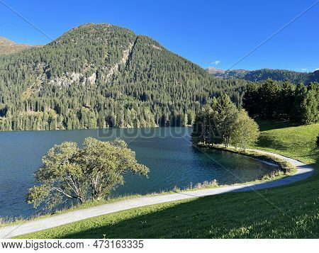 Sports And Recreational Trail Along The Alpine Lake Davos Or Loop Around Mountain Lake Davosersee, D
