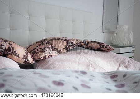 Pink Decorative Pillows On The Bed Linen. Double Bridal Bed With Pillows And Thick Feather Duvet. Be