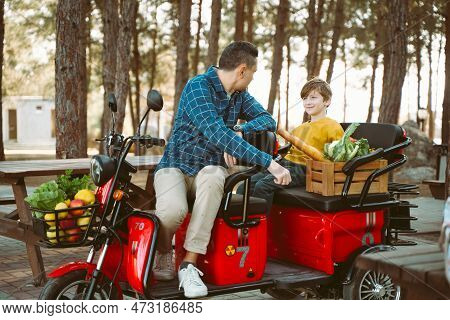 Farmer Father And School Boy Kid Delivered Wooden Crates With Vegetables To Camp Site For Picnic. Da