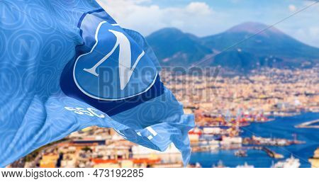 Naples, It, March 2023: Flag Of Napoli Football Team Waving With The Bay Of Naples And Mount Vesuviu