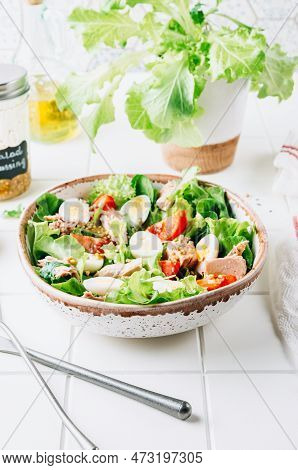 Healhty Tuna Salad With Tomato, Quail Eggs, Lettuce And Salad Dressing With Olive Oil, Lemon Juice A