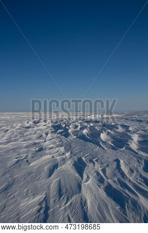 Beautiful Patterns Of Sastrugi, Parallel Wavelike Ridges Caused By Winds On Surface Of Hard Snow, Wi