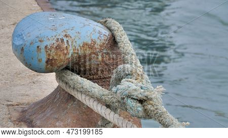 Lock Mooring Mechanism. Enlarged Image Of A Large Blue Metal Hook With A Giant Marine Cable For Towi