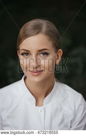 Smiling Confident Female Doctor With Lab Coat On Standing. Practician Woman