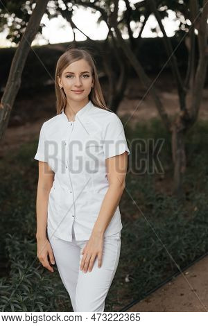 Smiling Confident Female Doctor With Lab Coat On Standing. Practician Woman