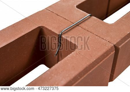 Pair Of Samples Bricks For Wall Building Bound With Metal Brace Isolated On White Background. Horizo