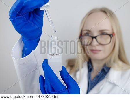 Niacinamide. Girl Applies Vitamin B3 To Her Face. Laboratory Research. Skincare. Dermatological Seru