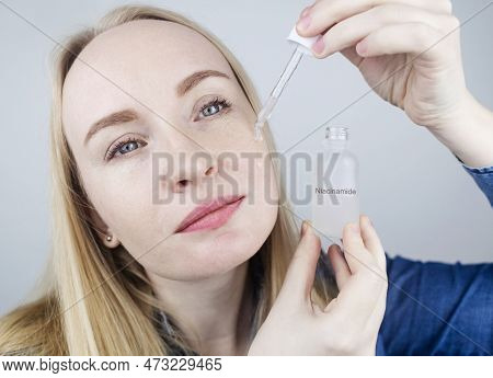 Niacinamide. Girl Applies Vitamin B3 To Her Face. Laboratory Research. Skincare. Dermatological Seru