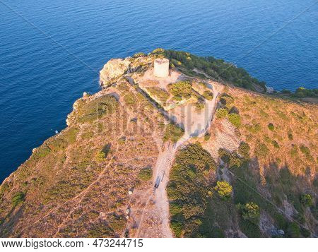 Aetial View Of Torre De Montgó Tower And And Caves Near Montgó Cliff In Town L'escala, Catalonia, Sp