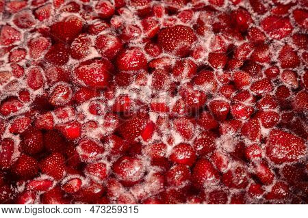 Process Of Making Homemade Raspberry Jam. Red Sweet Syrup Boiling On The Stove Closeup. Strawberry J