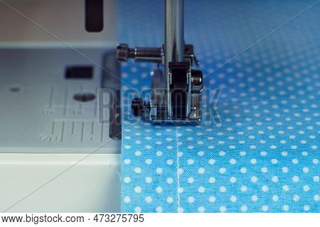 Close Up Sewing Machine Steel Part With Needle, Pressure Foot Stitching With Thread On Blue Fabric, 