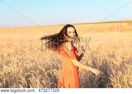 Young Woman In The Wheat Field. Look Back. Finding Inner Balance Concept. Copy Space.